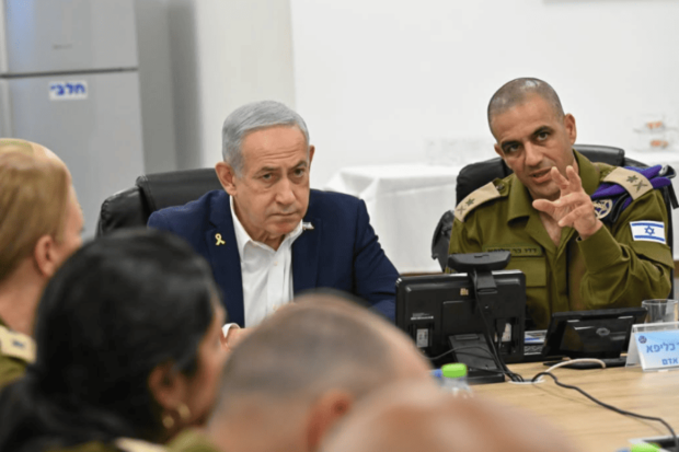 Benjamin Netanyahu en una reunión de seguridad con oficiales militares israelíes, con un militar gesticulando en primer plano.