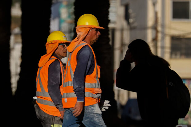 Dos trabajadores de la construcción se dirigen a su obra.
