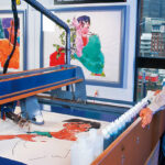 El artista Harold Cohen, pionero del arte generativo, ve cómo su programa AARON crea una pintura.